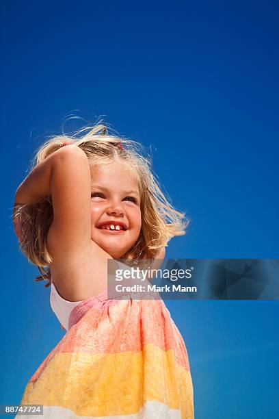 young girl smiling at the beach. - captiva island florida stock pictures, royalty-free photos & images