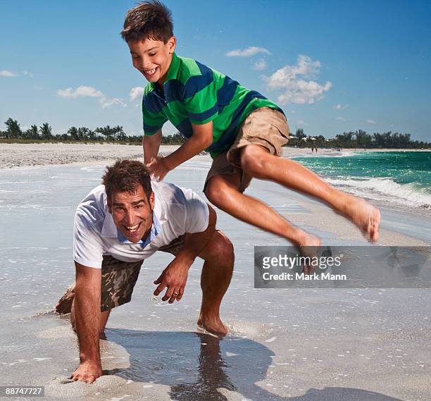 father and son playing at the beach. - captiva island stock-fotos und bilder