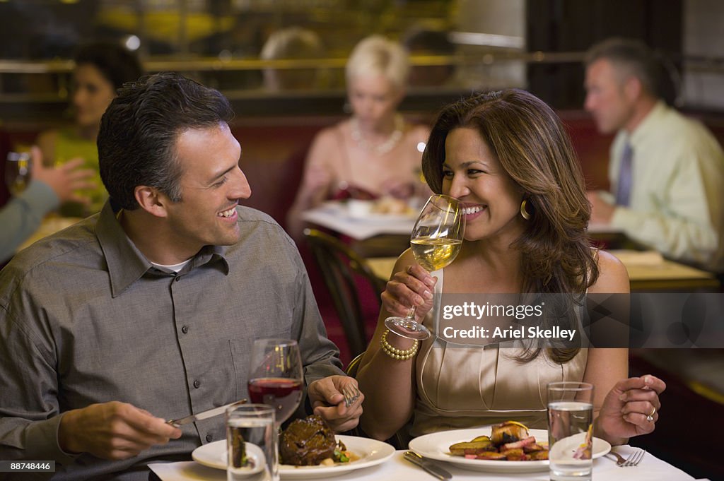 Hispanic couple having elegant dinner in restaurant