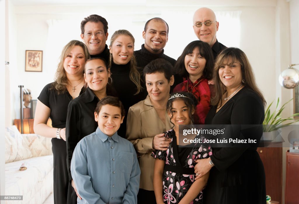 Multi-generation family posing in living room