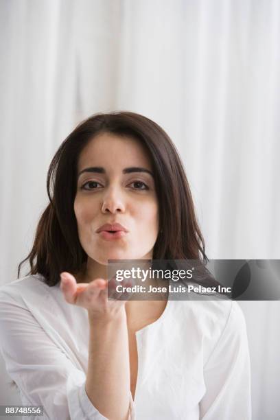 hispanic woman blowing kisses - blowing a kiss imagens e fotografias de stock