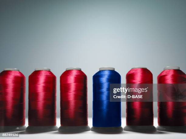 row of spools of thread - spool stock pictures, royalty-free photos & images