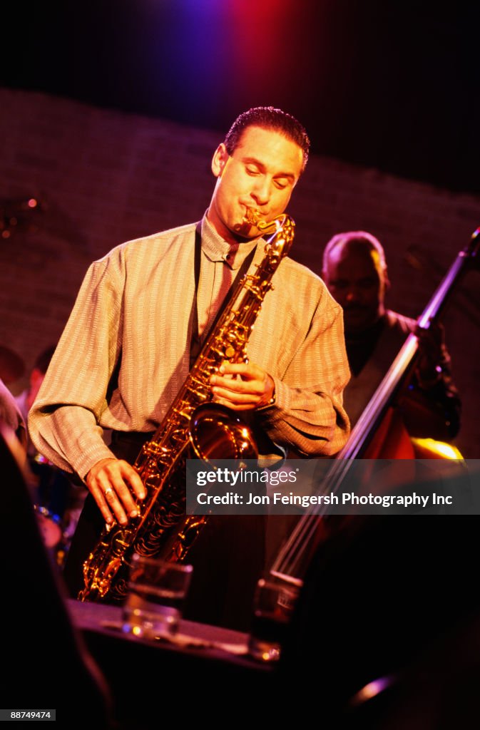 Man playing saxophone in nightclub