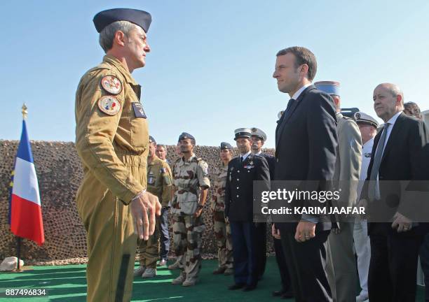 French President Emmanuel Macron is welcomed by French Air Force commander Christophe Oursel during his visit to French troops stationed at the...