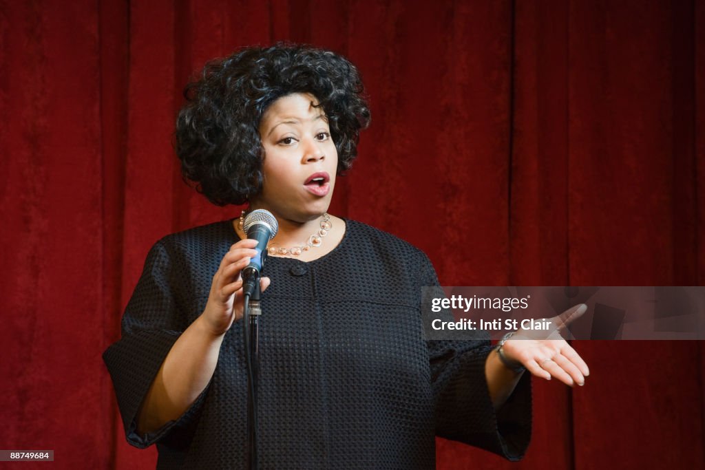 African woman singing on stage