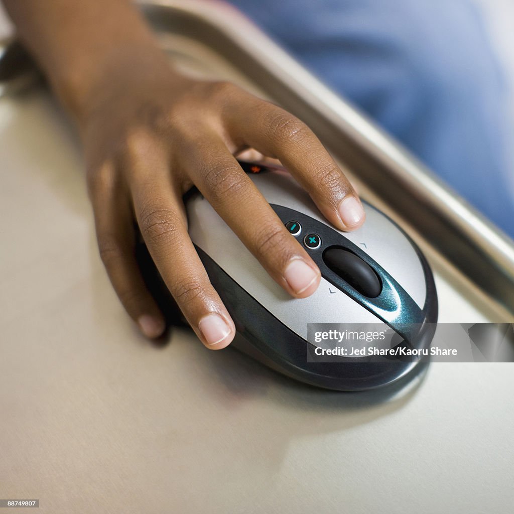 African girl's hand on computer mouse