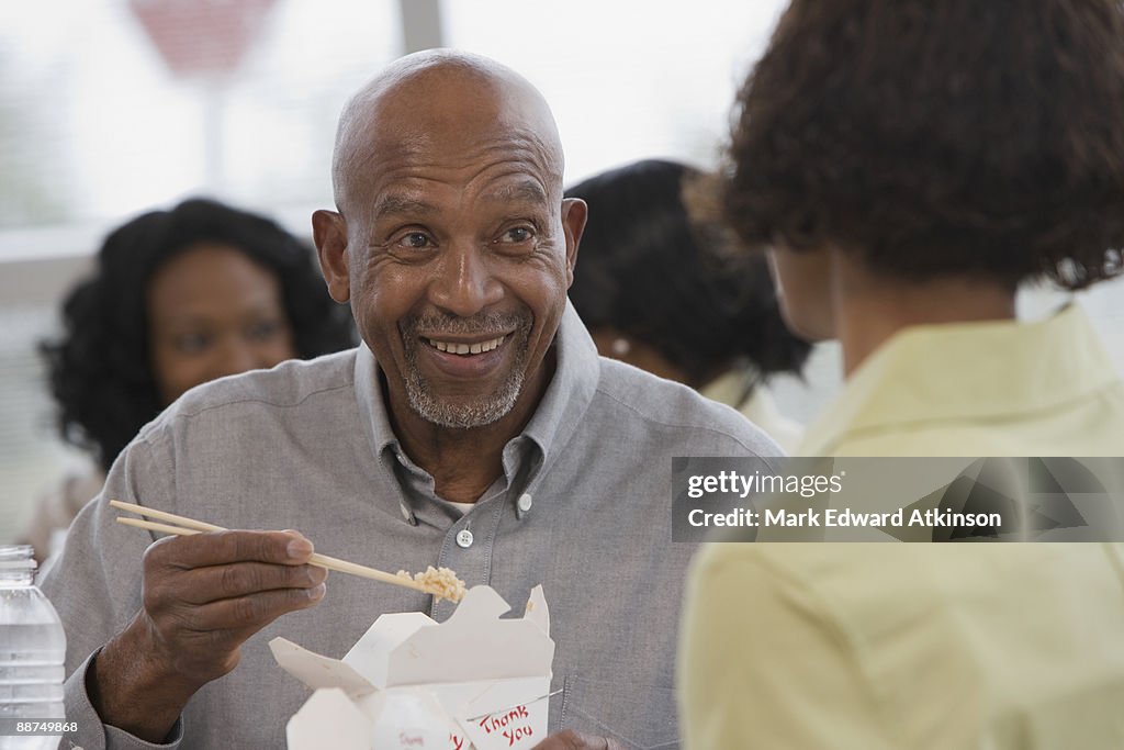 African man eating with chopsticks