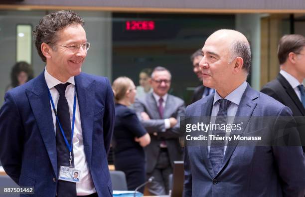 Dutch Minister of Finance Jeroen Dijsselbloem is talking with the EU Economic and Financial Affairs, Taxation and Customs Commissioner Pierre...