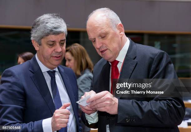 Portuguese Finance Minister Mario Centeno is giving his card to the EU Council Director-General Carsten Pillath prior an EcoFin Ministers meeting on...