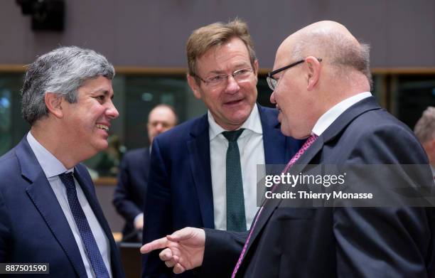 Portuguese Finance Minister Mario Centeno is talking with the Belgian Finance Minister Johan Van Overtveldt and the German Chief of Staff and acting...