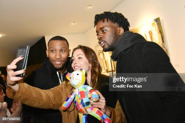 Actors Archibald Smith, Dounia Coesens and Dorel Hope attend Caroline Faindt Exhibition Preview at Espace Reduit on December 6, 2017 in Paris, France.