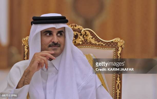 Qatari Emir Sheikh Tamim bin Hamad al-Thani is pictured during his meeting with the French president in the Qatari capital Doha on December 7, 2017....