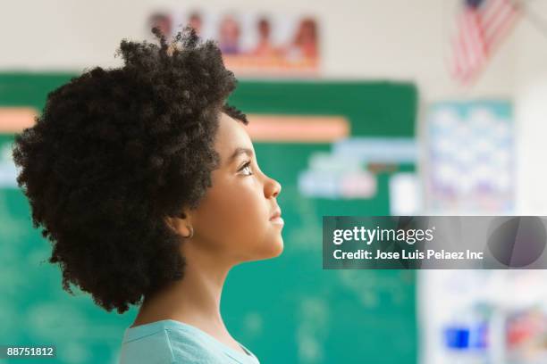 mixed race girl in classroom - girl side view stockfoto's en -beelden