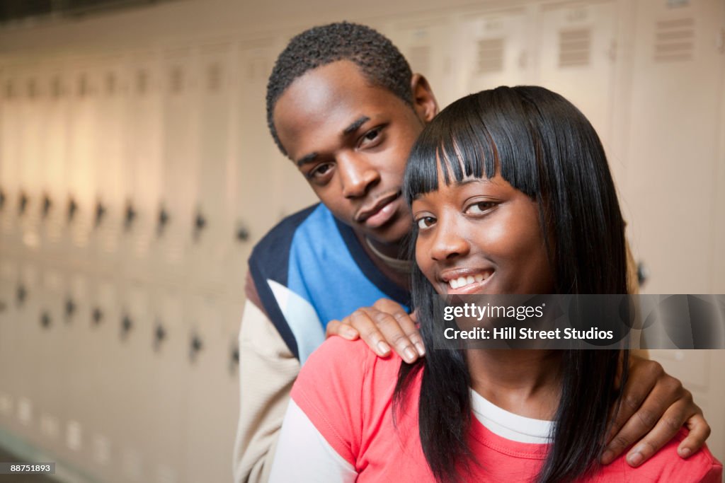African teenage couple in school hallway