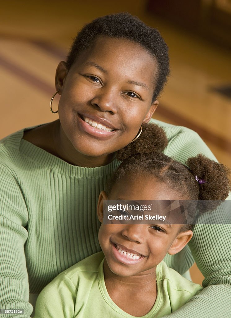 African mother and daughter smiling