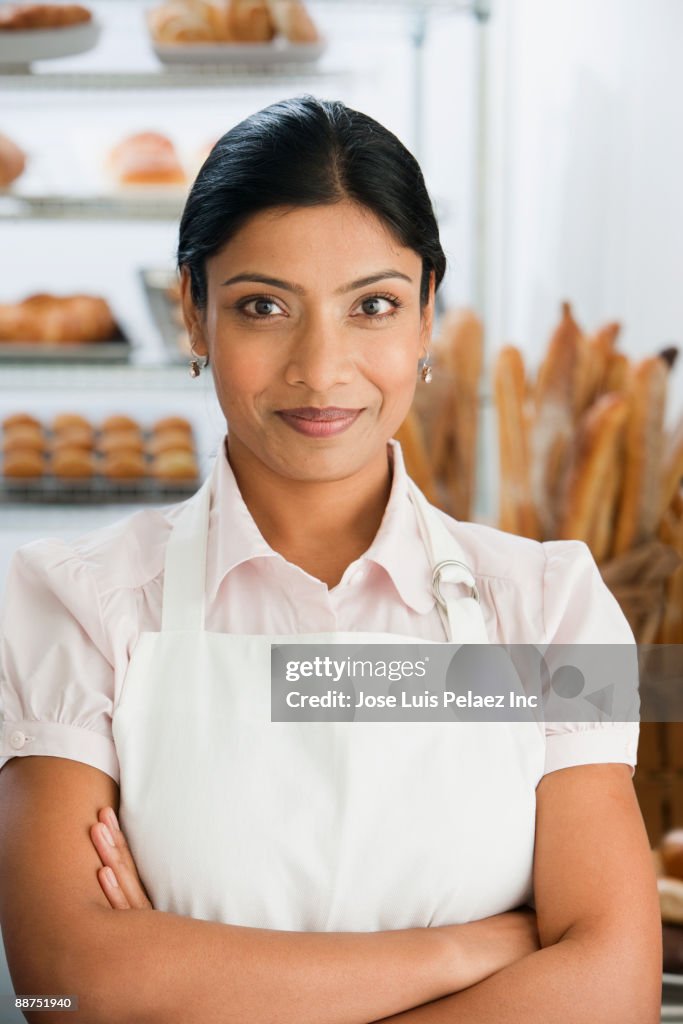 African woman with arms crossed in bakery