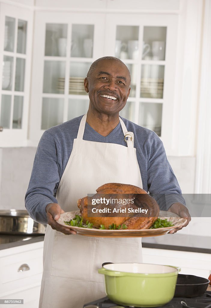 African man holding Thanksgiving turkey