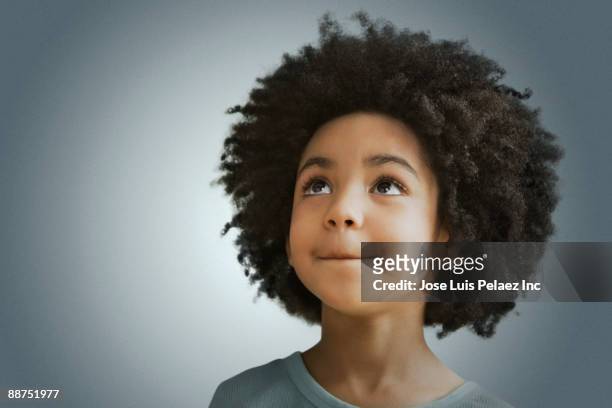 mixed race girl looking in curiously - afro frisur stock-fotos und bilder