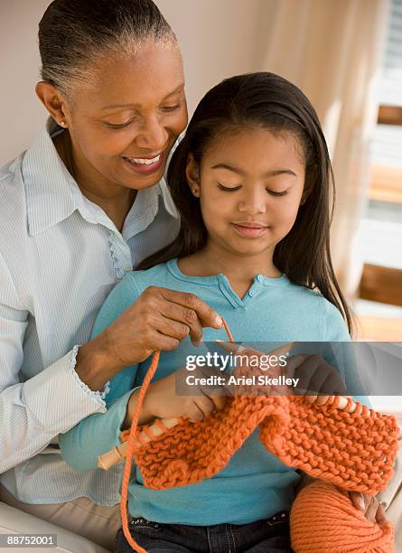 african woman teaching granddaughter how to knit - old granny knitting stock pictures, royalty-free photos & images