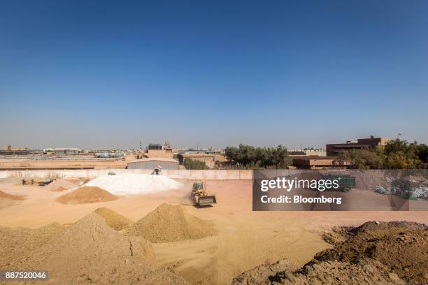 Tractor travels between piles of different varieties of clay in a preparation unit at the Shabbir Tiles & Ceramics Ltd. Production facility in...