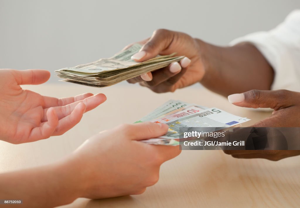Woman exchanging Euro notes for US currency