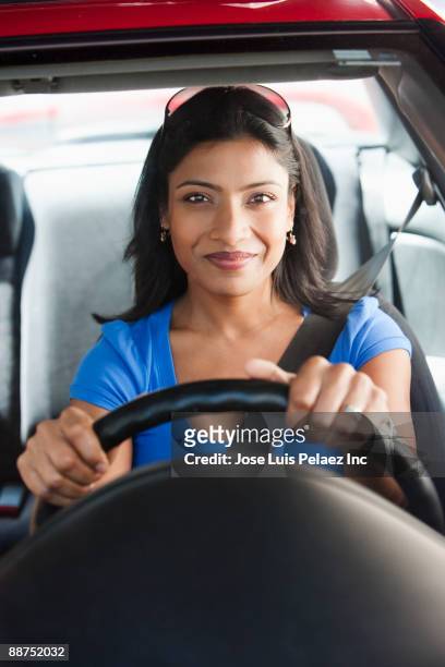 smiling indian woman driving car - driver front view stock pictures, royalty-free photos & images