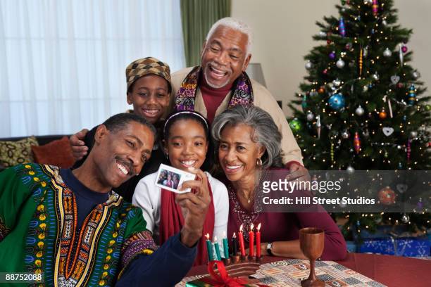 african couple with family celebrating kwanzaa - kwanzaa fotografías e imágenes de stock