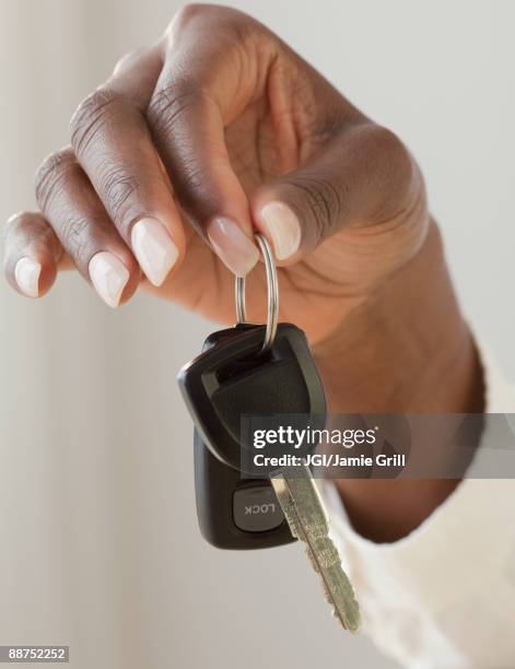 african woman holding car keys - car keys hand foto e immagini stock