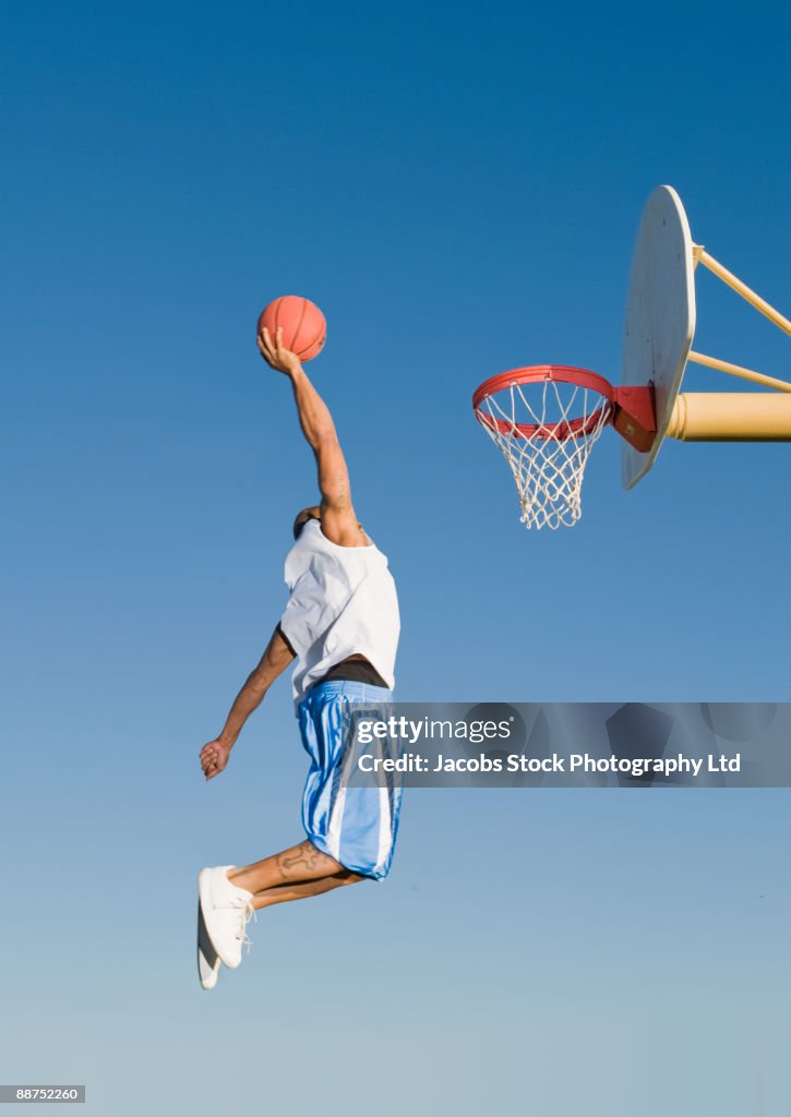 Man playing basketball outdoors