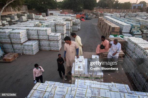 Workers load boxes of tiles onto a truck at the Shabbir Tiles & Ceramics Ltd. Production facility in Karachi, Pakistan, on Wednesday, Dec. 6, 2017....