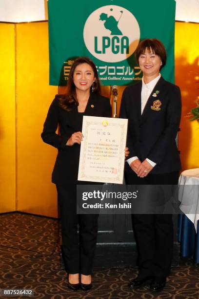 Bo-Mee Lee of South Korea receives a certificate from LPGA president Hiromi Kobayashi during the Ladies Professional Golfers' Association of Japan...