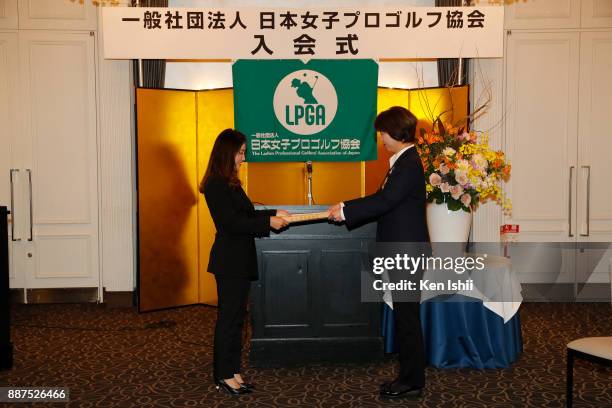 Bo-Mee Lee of South Korea receives a certificate from LPGA president Hiromi Kobayashi during the Ladies Professional Golfers' Association of Japan...