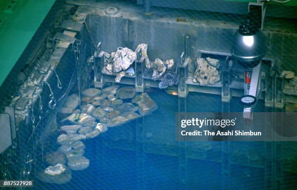 Debris is visible near the surface of the storage pool for spent nuclear fuel near the top of the No. 3 reactor building at the Fukushima Daiichi...