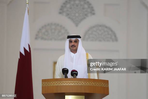 Qatari Emir Sheikh Tamim bin Hamad al-Thani delivers a speech during a press conference with the French president following the signing of agreements...