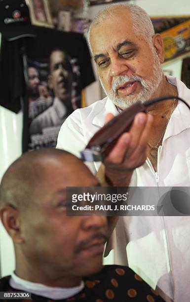 Barber LawrenceTolliver talks about Michael Jackson's life as he cuts the hair of Waymon Martin, 55-yrs, at L.Tolliver's Barber Shop June 29, 2009 in...