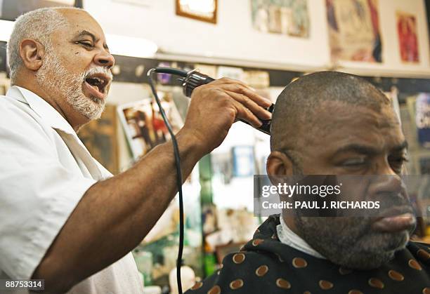 Barber LawrenceTolliver talks about Michael Jackson's life as he cuts the hair of Larry Gamble, at L.Tolliver's Barber Shop June 29, 2009 in Los...