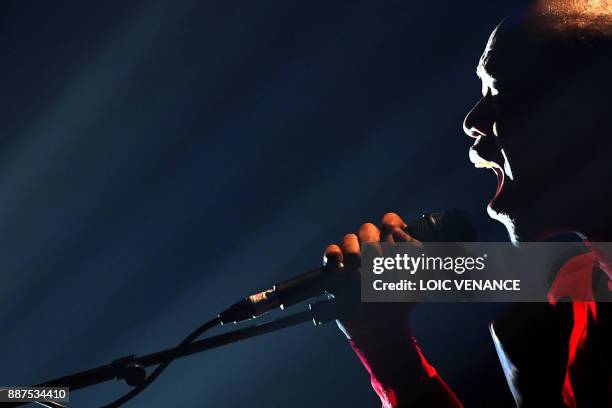 South African singer Nakhane performs on stage at the Aire Libre concert hall, on December 6, 2017 in Saint-Jacques-de-la-Lande, outside Rennes, as...