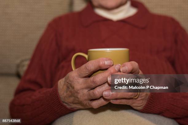 senior woman enjoying cosy moment with hot tea - woking stock pictures, royalty-free photos & images