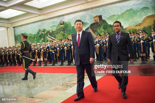 Maldives' President Abdulla Yameen and China's President Xi Jinping walk during a welcome ceremony at the Great Hall of the People in Beijing on...