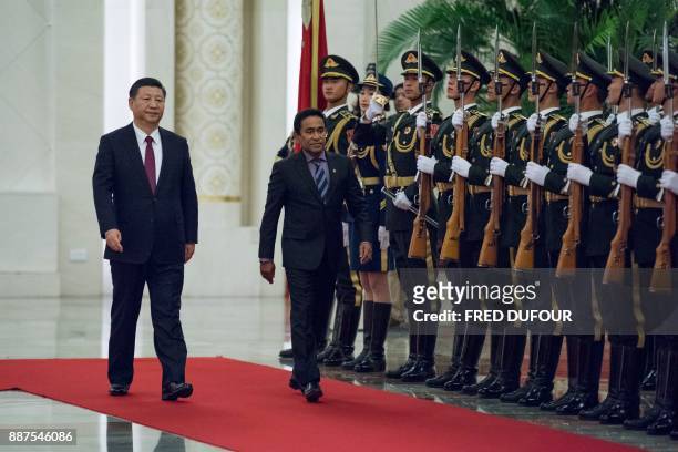 Maldives' President Abdulla Yameen and China's President Xi Jinping review the Chinese honour guard during a welcome ceremony at the Great Hall of...