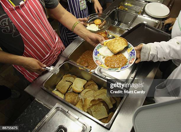 Staff inside Goose Hall, the Glastonbury Festival on-site caterers, cook breakfast for over 600 festival litter pickers who were signed on to start...