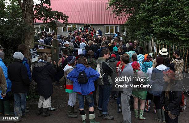 Litter-pickers and festival workers queue outside Goose Hall, the Glastonbury Festival on-site caterers, as they wait for breakfast and to sign up to...