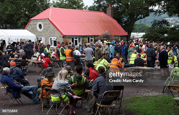 Litter-pickers and festival workers queue outside Goose Hall, the Glastonbury Festival on-site caterers, as they wait for breakfast and to sign up to...