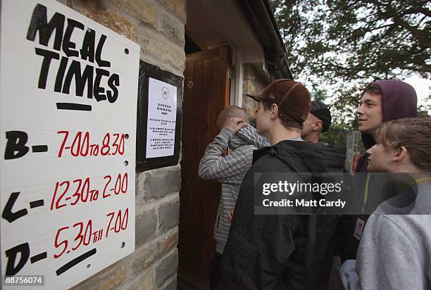Litter-pickers and festival workers queue outside Goose Hall, the Glastonbury Festival on-site caterers, as they wait for breakfast and to sign up to...