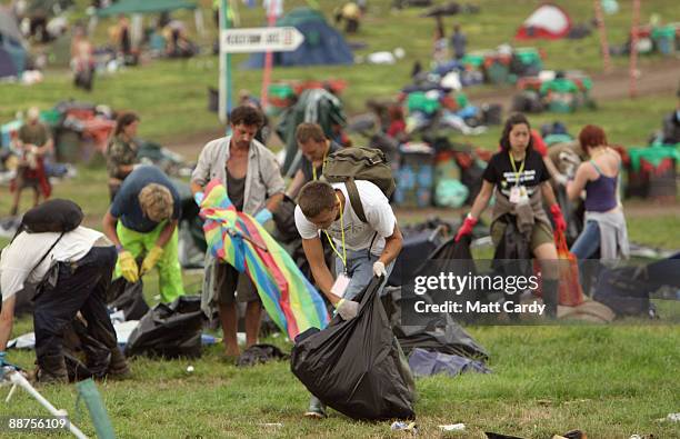 Llitter-pickers, some of the 600 who were signed on to start today, pick up some of the rubbish on the start of the big clear-up of the Glastonbury...