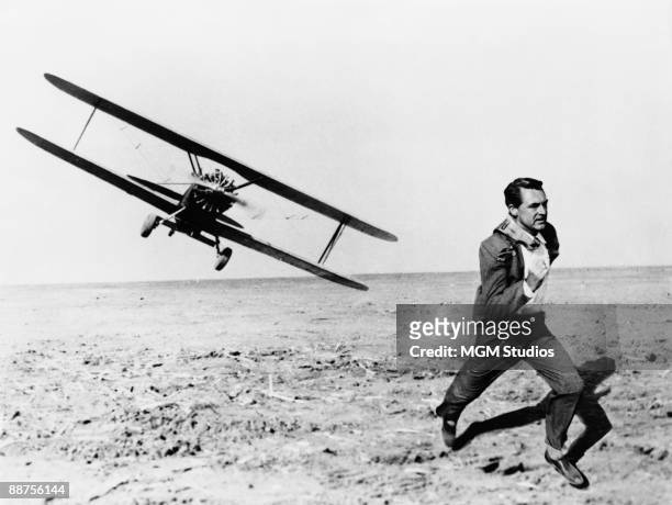 British-born American actor Cary Grant is pursued across a cornfield by a cropduster in the Hitchcock film 'North by Northwest', 1959.