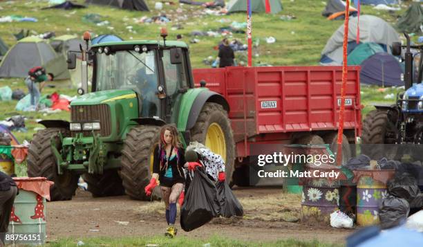 Litter-pickers, some of the 600 who were signed on to start today, pick up some of the rubbish on the start of the big clear-up of the Glastonbury...