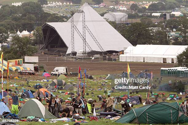 Litter-pickers, some of the 600 who were signed on to start today, pick up some of the rubbish on the start of the big clear-up of the Glastonbury...