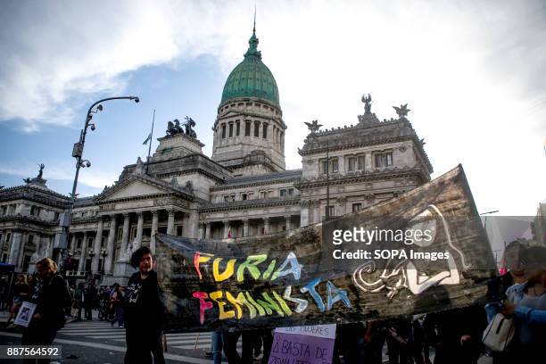 With the city's iconic Congreso buildings in the background, women seen carrying feminist banners as the protest begins. Marching from the nation's...