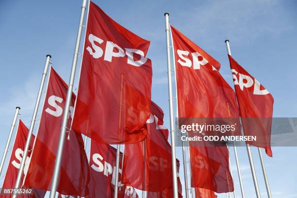 Red flags with the SPD logo float in the wind at the start of the party congress of Germany's Social Democrats party in Berlin, on December 7, 2017....